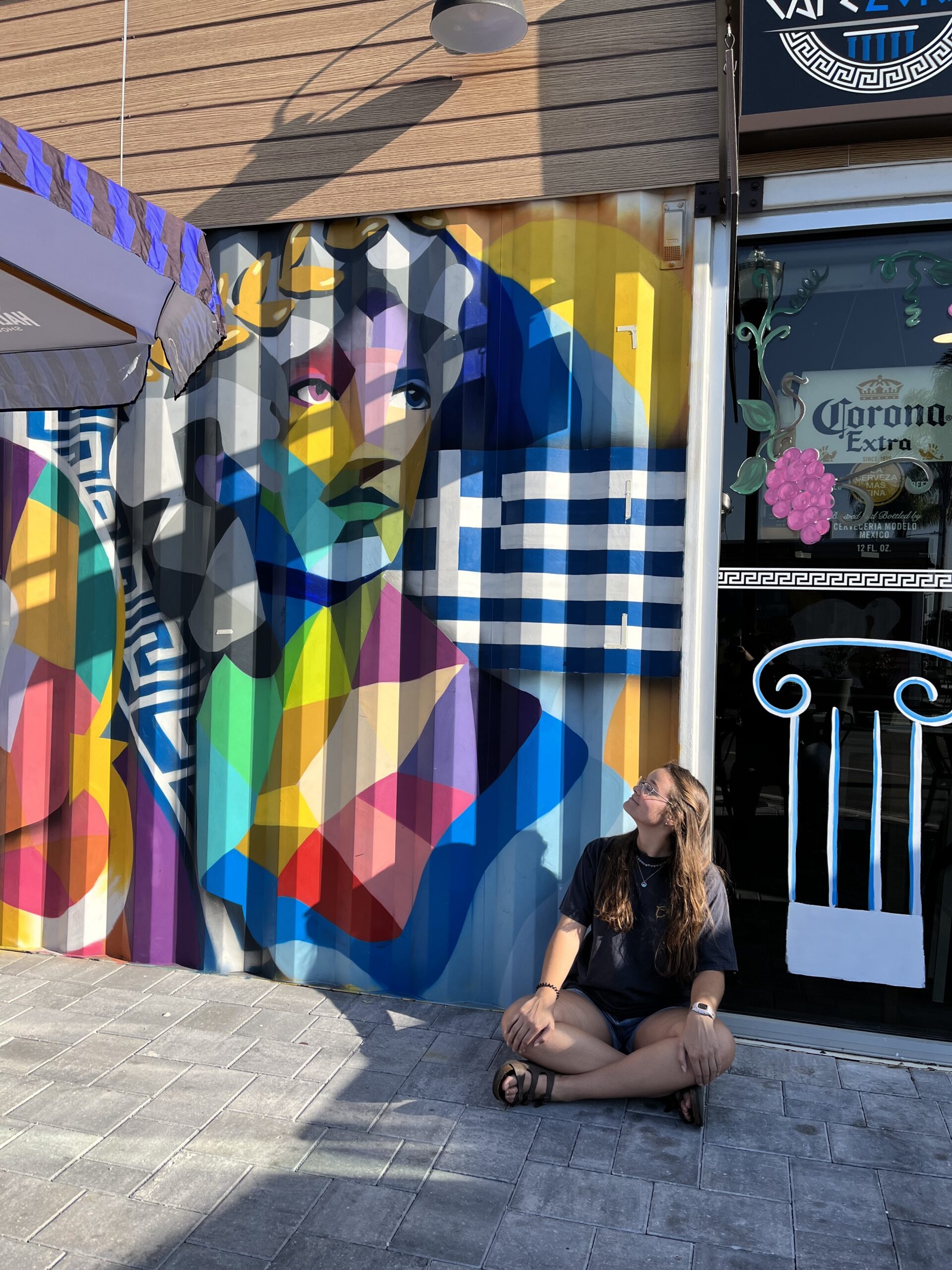 Tiffani sitting down looking at a mural